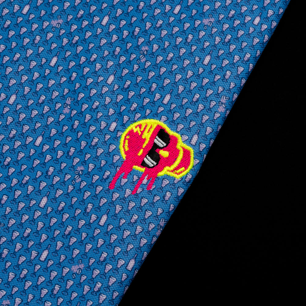 SWAG Golf x Peter Millar blue short sleeve performance golf polo shirt with embroidered sideways melting skull over the left chest.