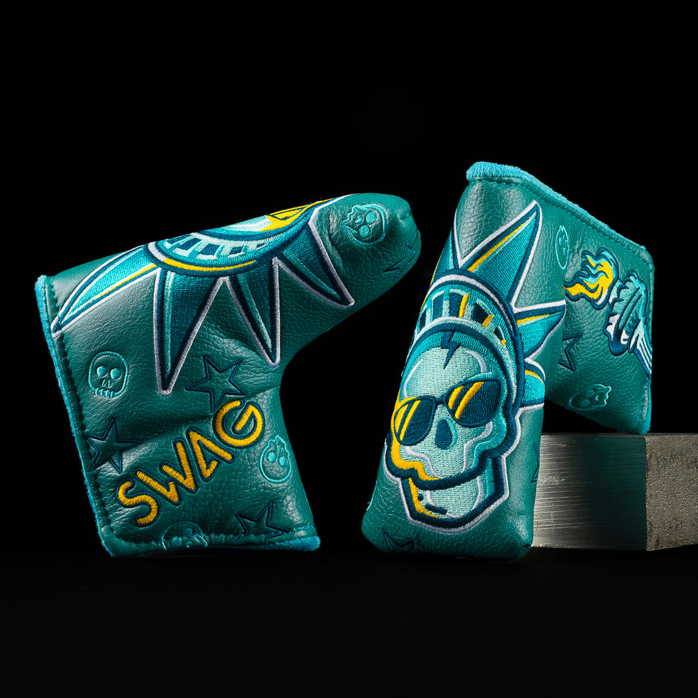 Statue of Liberty inspired skull blade putter cover in teal with crown and sunglasses embroidery.